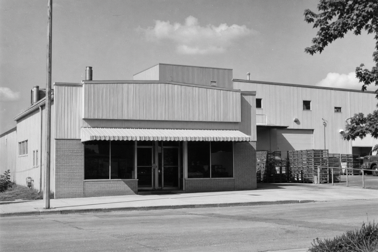 Archival-style photo of a small Midwestern snack company building
